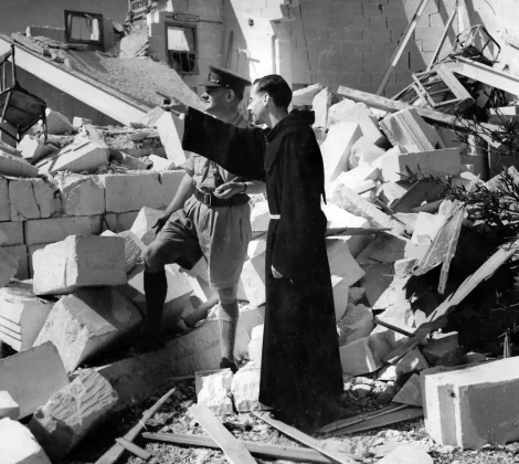 Major Sam Staples and Father Hersey at the Scout Hall, after it was bombed in 1942.