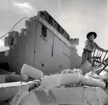 Ed searches for anything worth salvaging at the Scout Hall after the bombing.